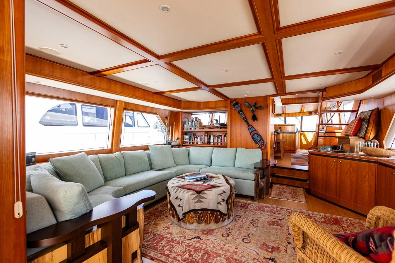 The salon features a spacious seating area with a large, comfortable sofa and elegant wooden accents. aboard DAWN TRADER VII Yacht for Sale