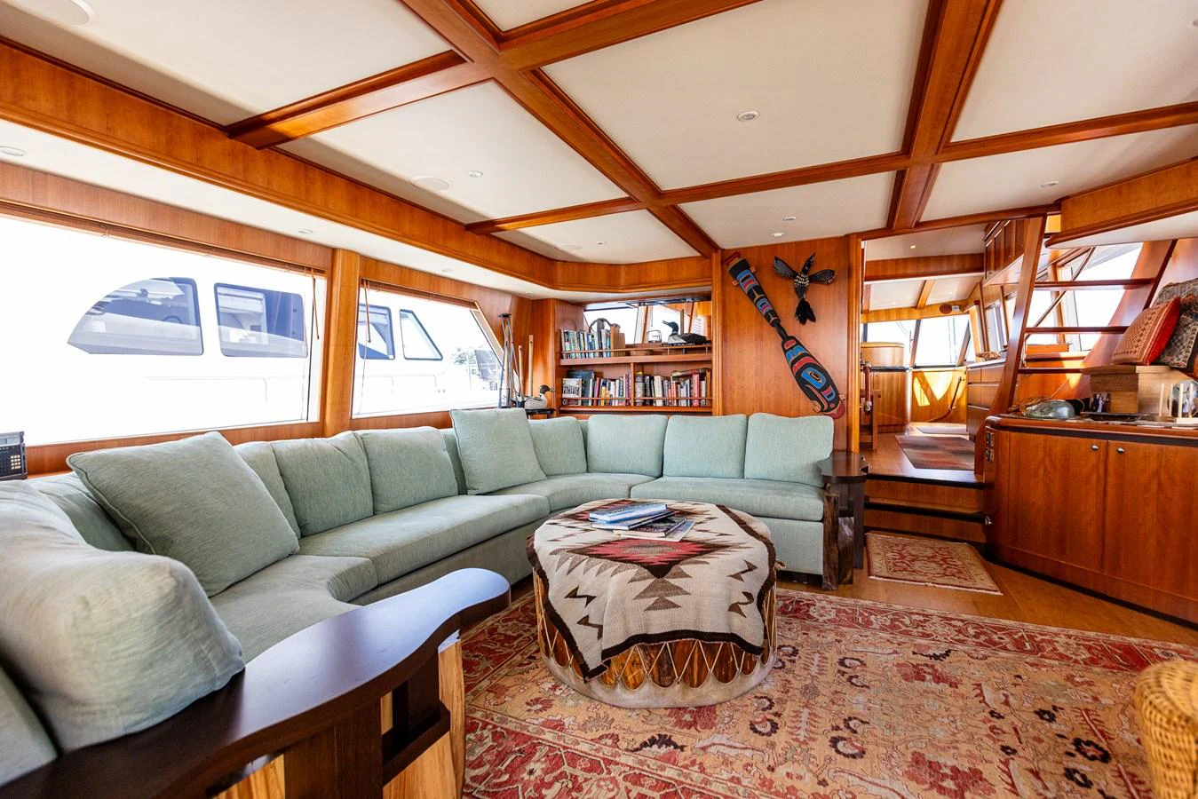 The yacht's salon features a spacious seating area with a large, comfortable sofa and a stylish coffee table, creating a warm and inviting atmosphere. aboard DAWN TRADER VII Yacht for Sale