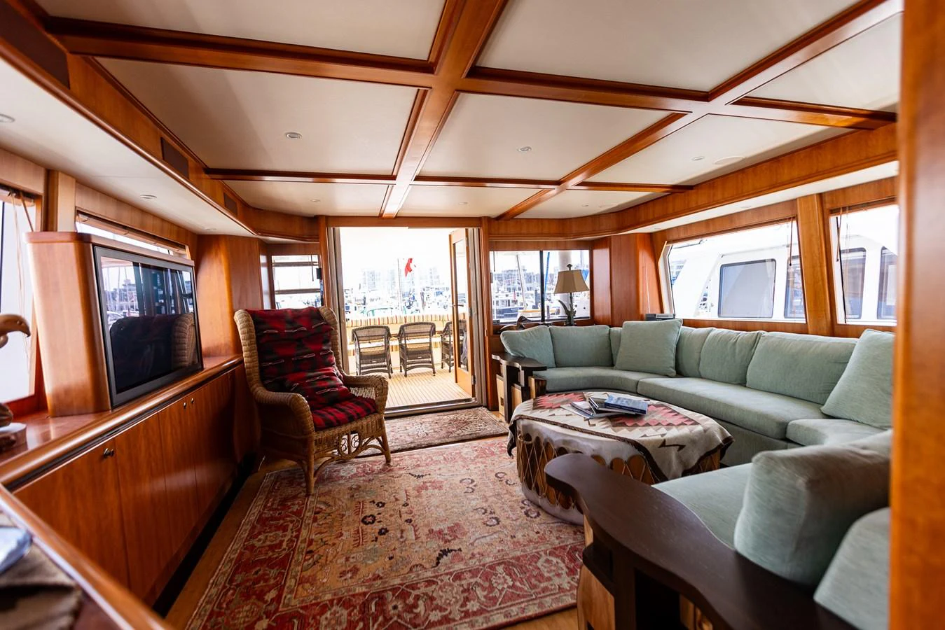 The salon features a spacious seating area with elegant wooden finishes and large windows offering ample natural light. aboard DAWN TRADER VII Yacht for Sale