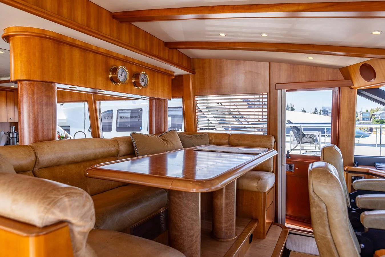 The yacht's dining area features plush seating and a polished wooden table, creating a warm and inviting atmosphere. aboard DAWN TRADER VII Yacht for Sale