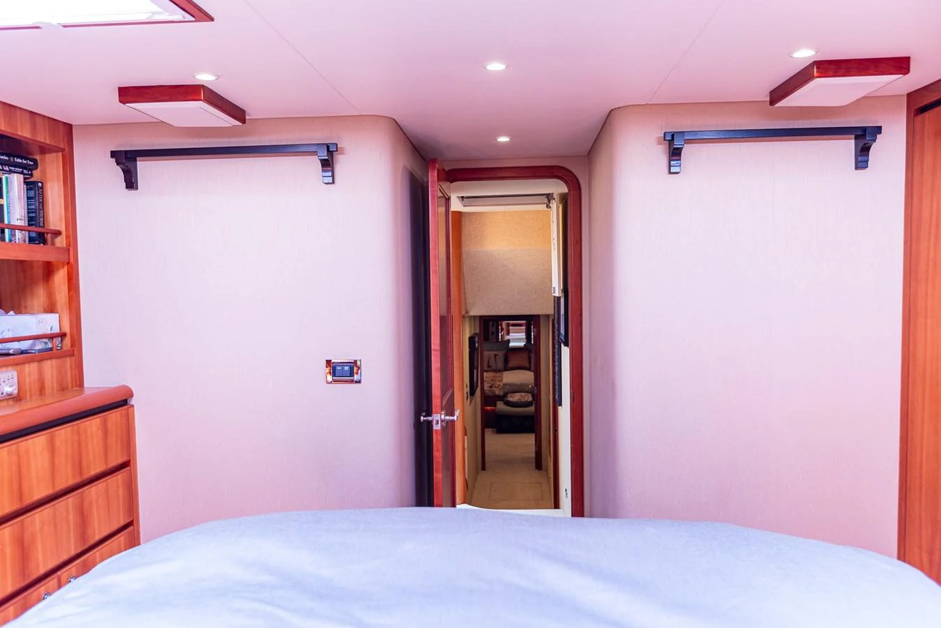 The image showcases a cozy stateroom with a view towards the hallway and another room. aboard DAWN TRADER VII Yacht for Sale