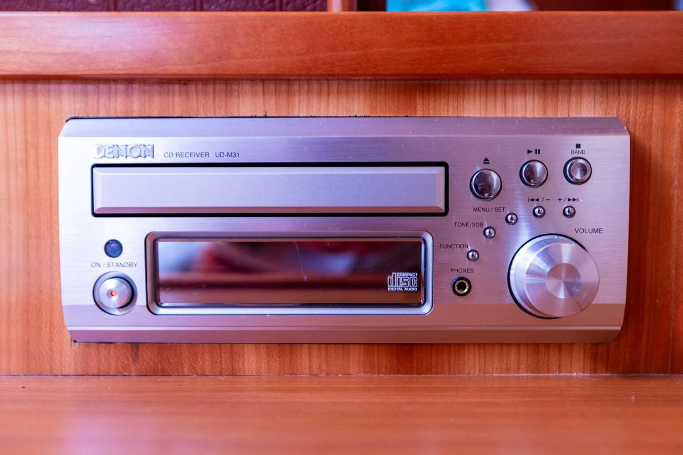 A close-up of a Denon CD receiver installed on a wooden panel. aboard DAWN TRADER VII Yacht for Sale