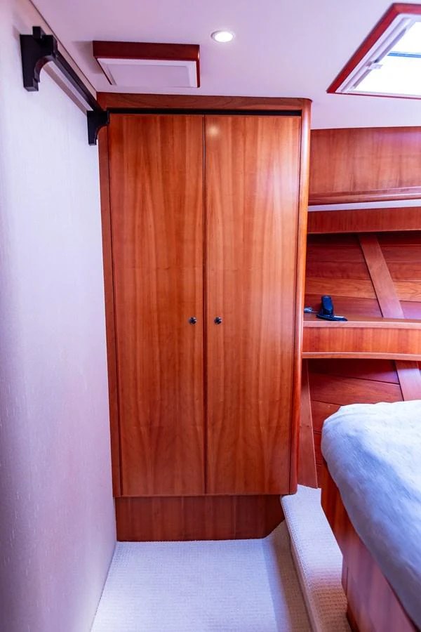 The image showcases a well-crafted wooden cabinet within the yacht's interior. aboard DAWN TRADER VII Yacht for Sale