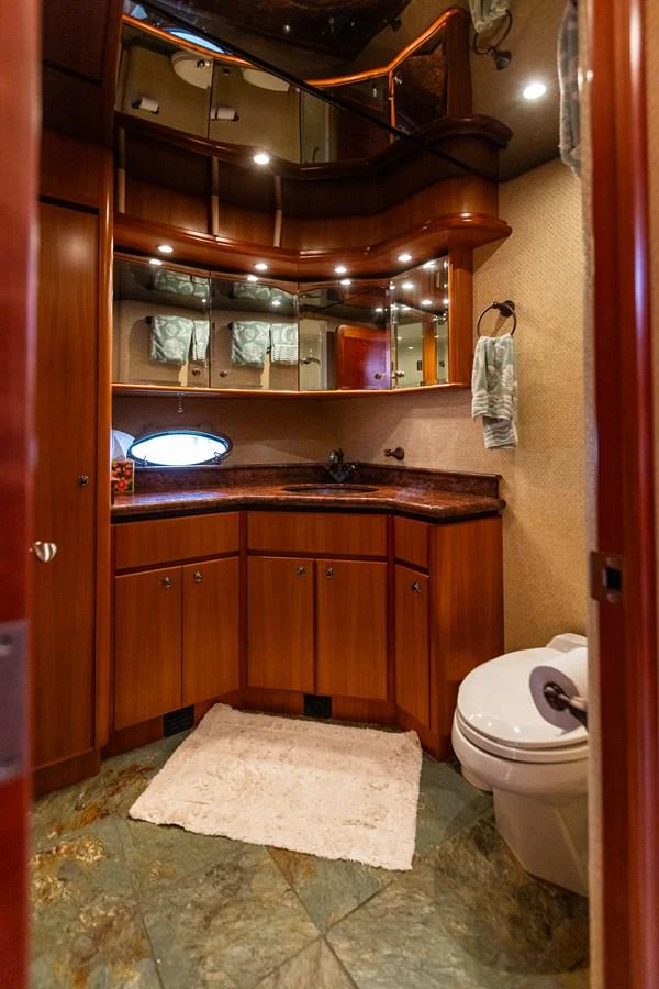A luxurious yacht bathroom with wooden cabinetry and elegant fixtures. aboard DAWN TRADER VII Yacht for Sale