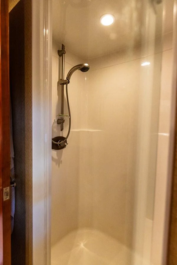 A pristine shower area with modern fixtures and warm lighting. aboard DAWN TRADER VII Yacht for Sale