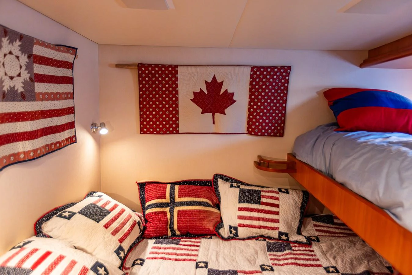 A cozy cabin with patriotic-themed bedding and decor. aboard DAWN TRADER VII Yacht for Sale
