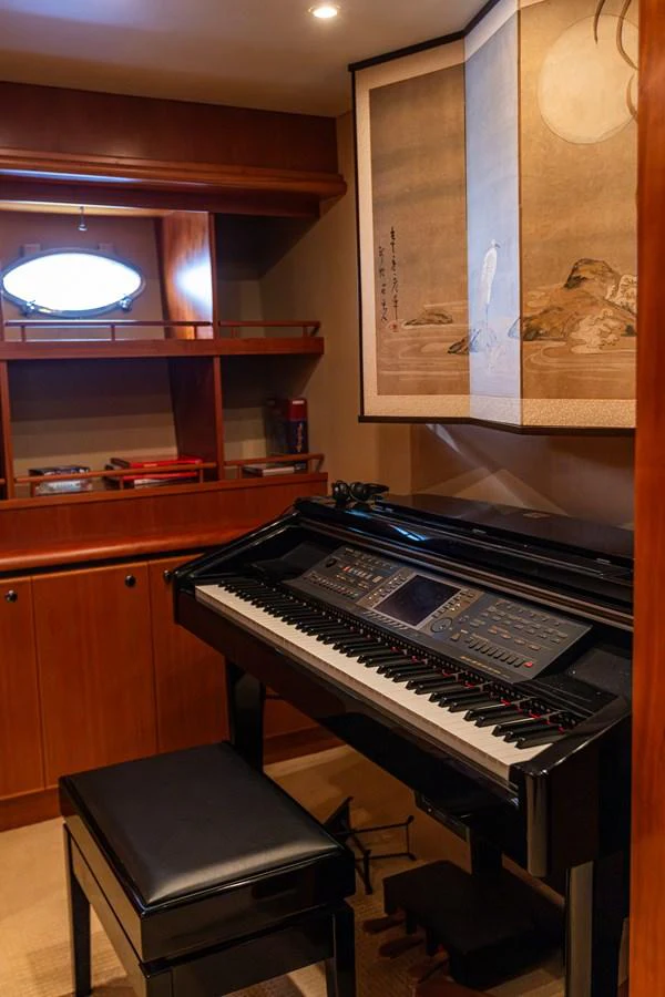 A cozy interior space featuring a digital piano and elegant wall art. aboard DAWN TRADER VII Yacht for Sale