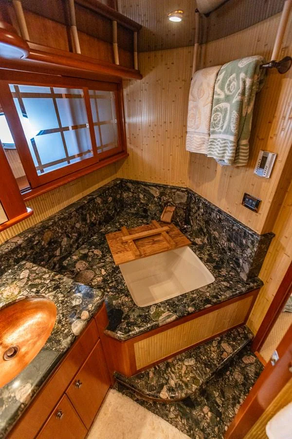 A compact and well-appointed galley with rich wood finishes and a granite countertop. aboard DAWN TRADER VII Yacht for Sale