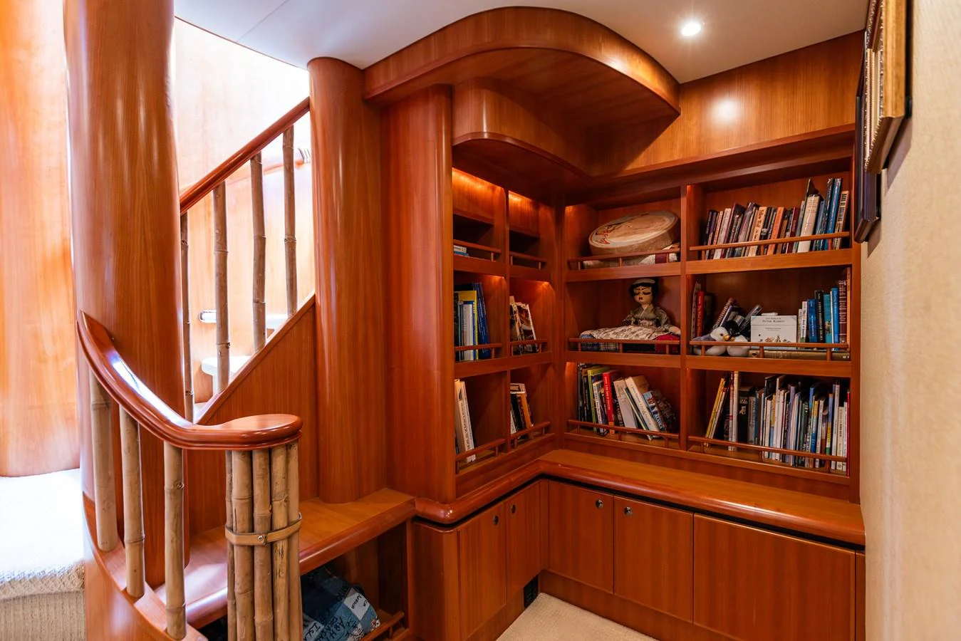 The yacht's library features warm wooden tones and a cozy atmosphere, perfect for relaxation and reading. aboard DAWN TRADER VII Yacht for Sale