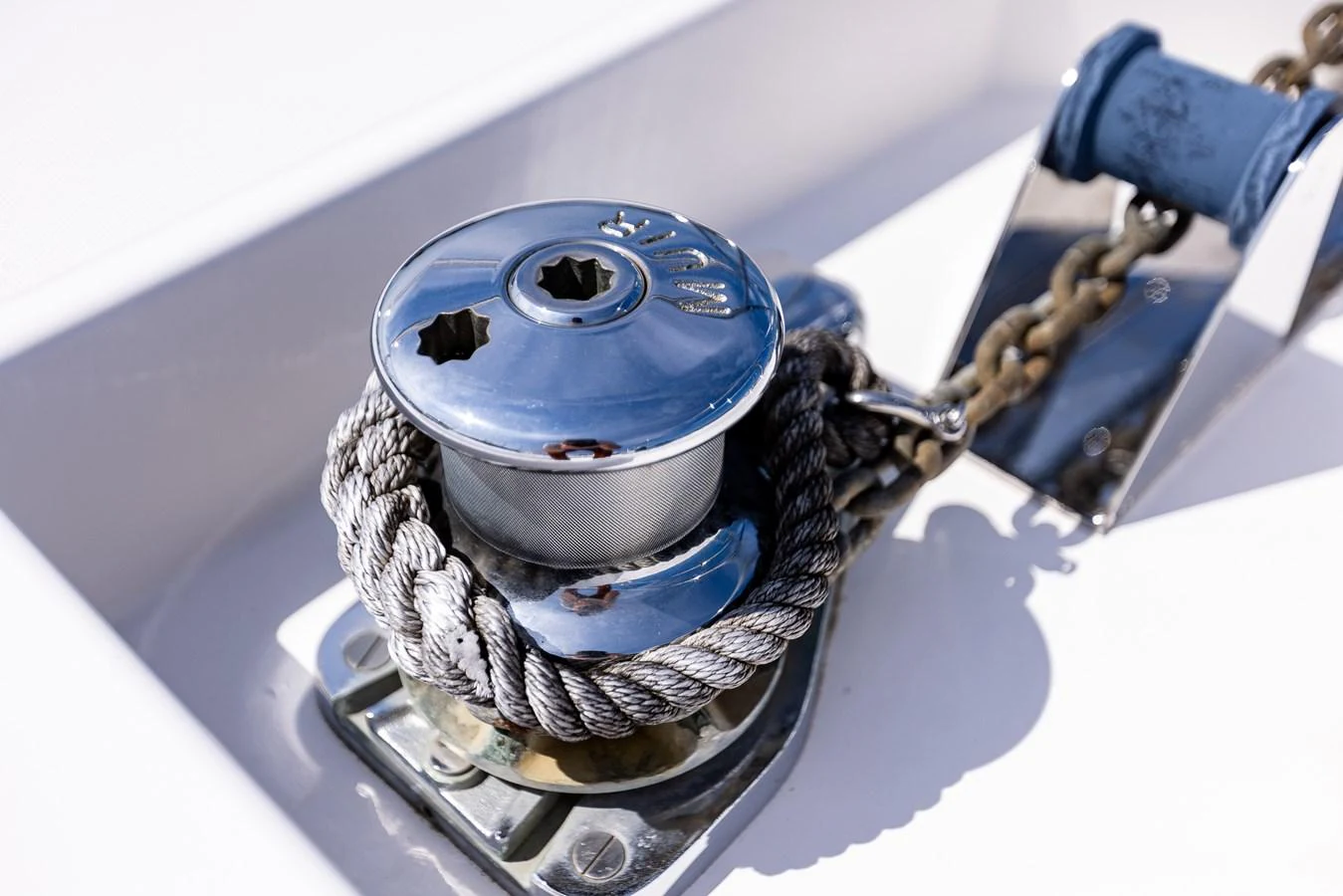 A close-up of a polished yacht winch and anchor chain mechanism. aboard DAWN TRADER VII Yacht for Sale