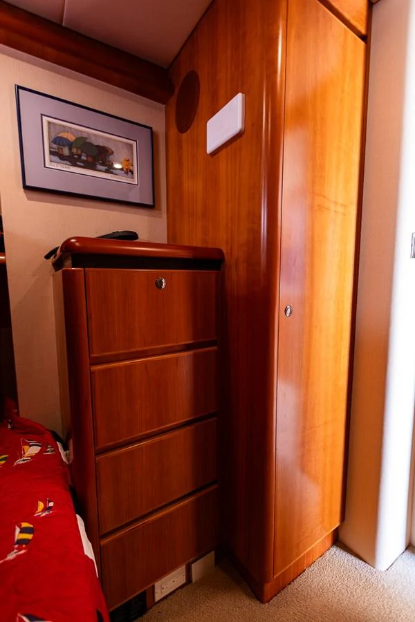 A cozy interior space featuring wooden cabinetry and a framed artwork. aboard DAWN TRADER VII Yacht for Sale