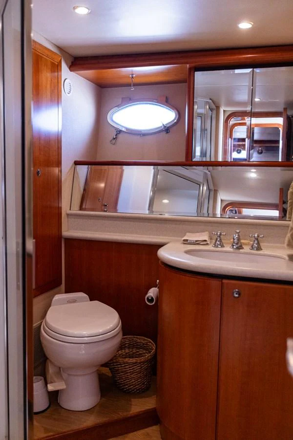 A well-appointed yacht bathroom featuring wooden cabinetry and modern fixtures. aboard DAWN TRADER VII Yacht for Sale