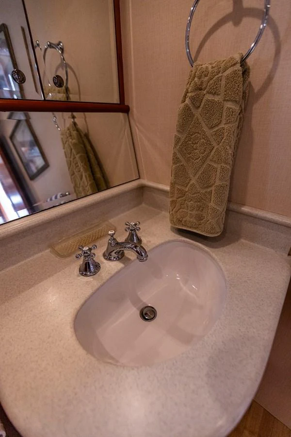 A well-appointed bathroom sink area with a towel ring and elegant fixtures. aboard DAWN TRADER VII Yacht for Sale
