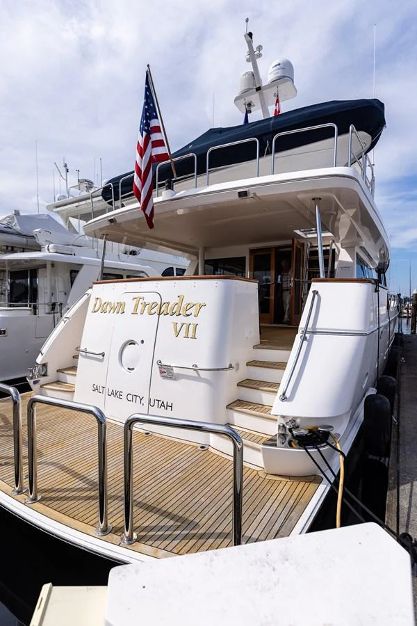 The yacht's aft deck features a welcoming staircase and elegant design, perfect for boarding and relaxation. aboard DAWN TRADER VII Yacht for Sale