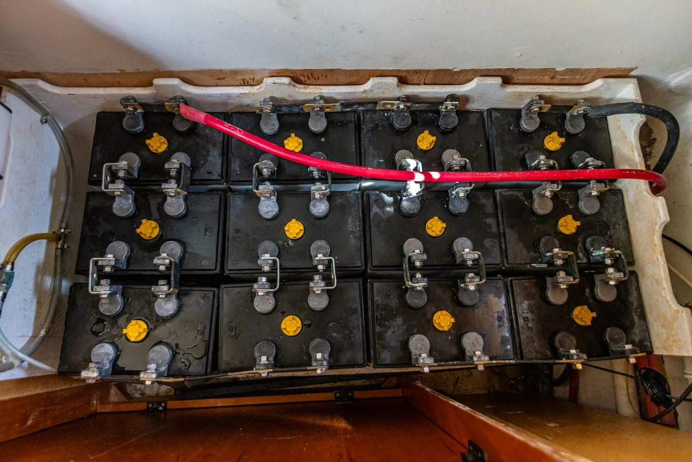 The image shows a neatly arranged battery bank in the yacht's engine room. aboard DAWN TRADER VII Yacht for Sale