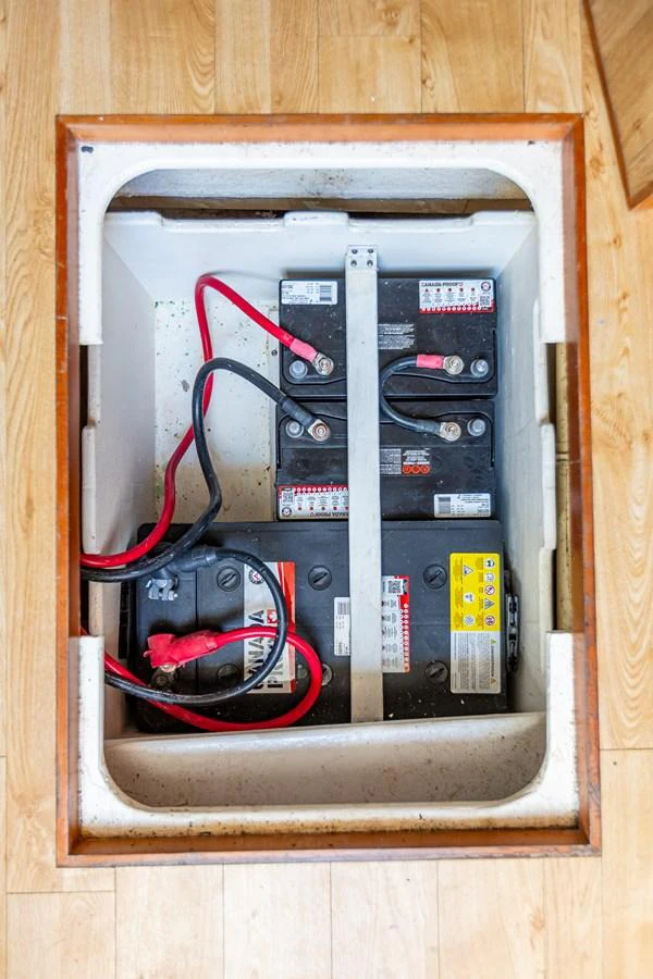 The image shows the yacht's battery compartment with multiple batteries and wiring. aboard DAWN TRADER VII Yacht for Sale