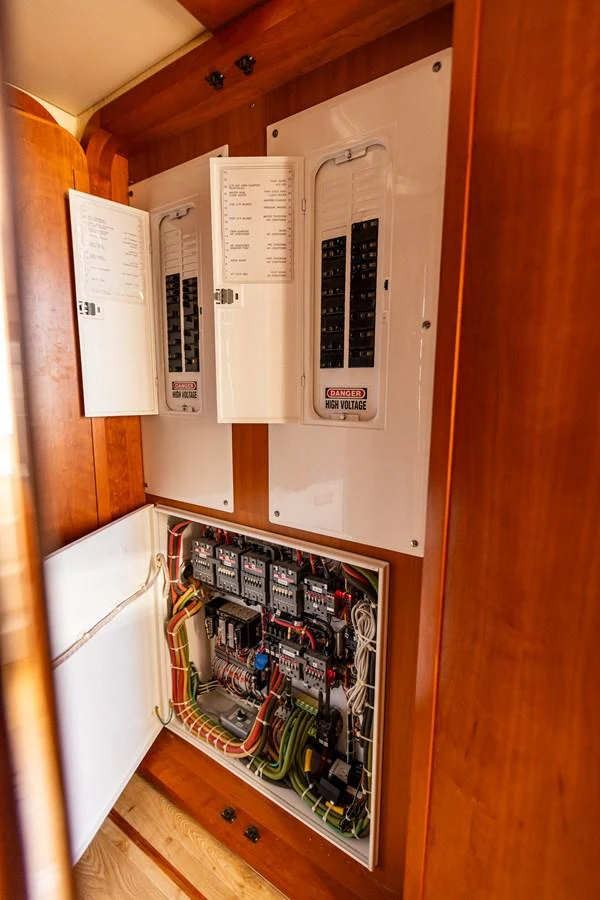 The image showcases the yacht's electrical panel with detailed wiring and circuit breakers. aboard DAWN TRADER VII Yacht for Sale
