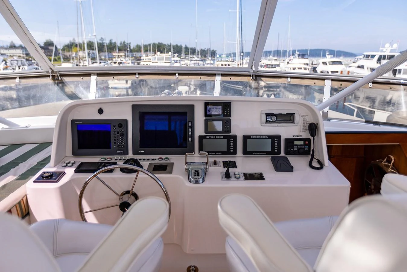 The helm station offers a sophisticated array of navigation and control equipment with a clear view of the marina. aboard DAWN TRADER VII Yacht for Sale