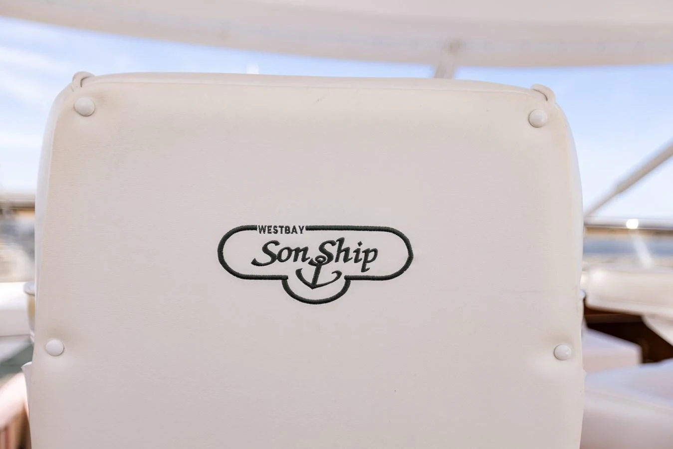 A close-up view of a yacht's seat with the logo 'Westbay SonShip' embroidered on it. aboard DAWN TRADER VII Yacht for Sale