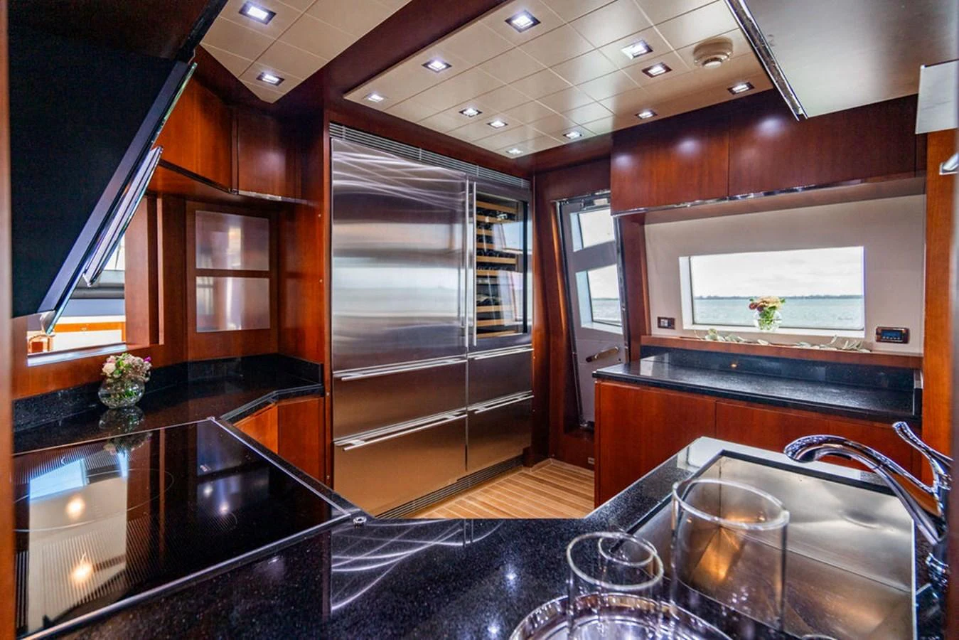 The yacht's galley features modern appliances, sleek countertops, and ample natural light. aboard BEAUTIFUL M Yacht for Sale