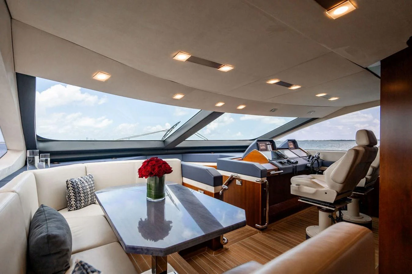 The helm area features a luxurious seating arrangement with panoramic windows offering stunning views. aboard BEAUTIFUL M Yacht for Sale