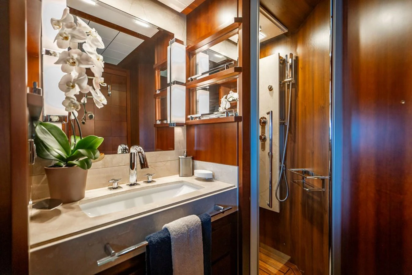A luxurious yacht bathroom with elegant wood finishes and modern fixtures. aboard BEAUTIFUL M Yacht for Sale