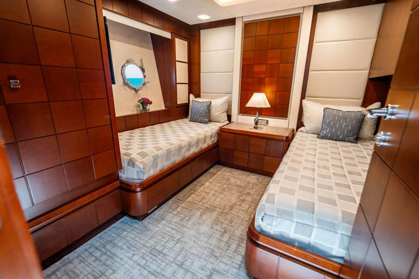 The twin stateroom features two single beds with elegant wood paneling and soft lighting. aboard BEAUTIFUL M Yacht for Sale