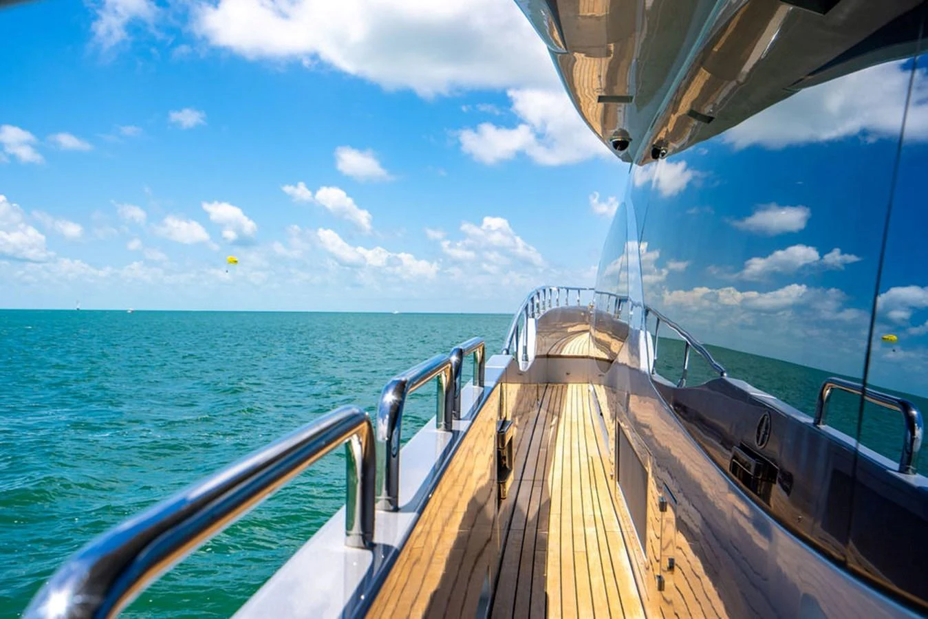 A sleek yacht cruising on calm waters under a bright blue sky. aboard BEAUTIFUL M Yacht for Sale