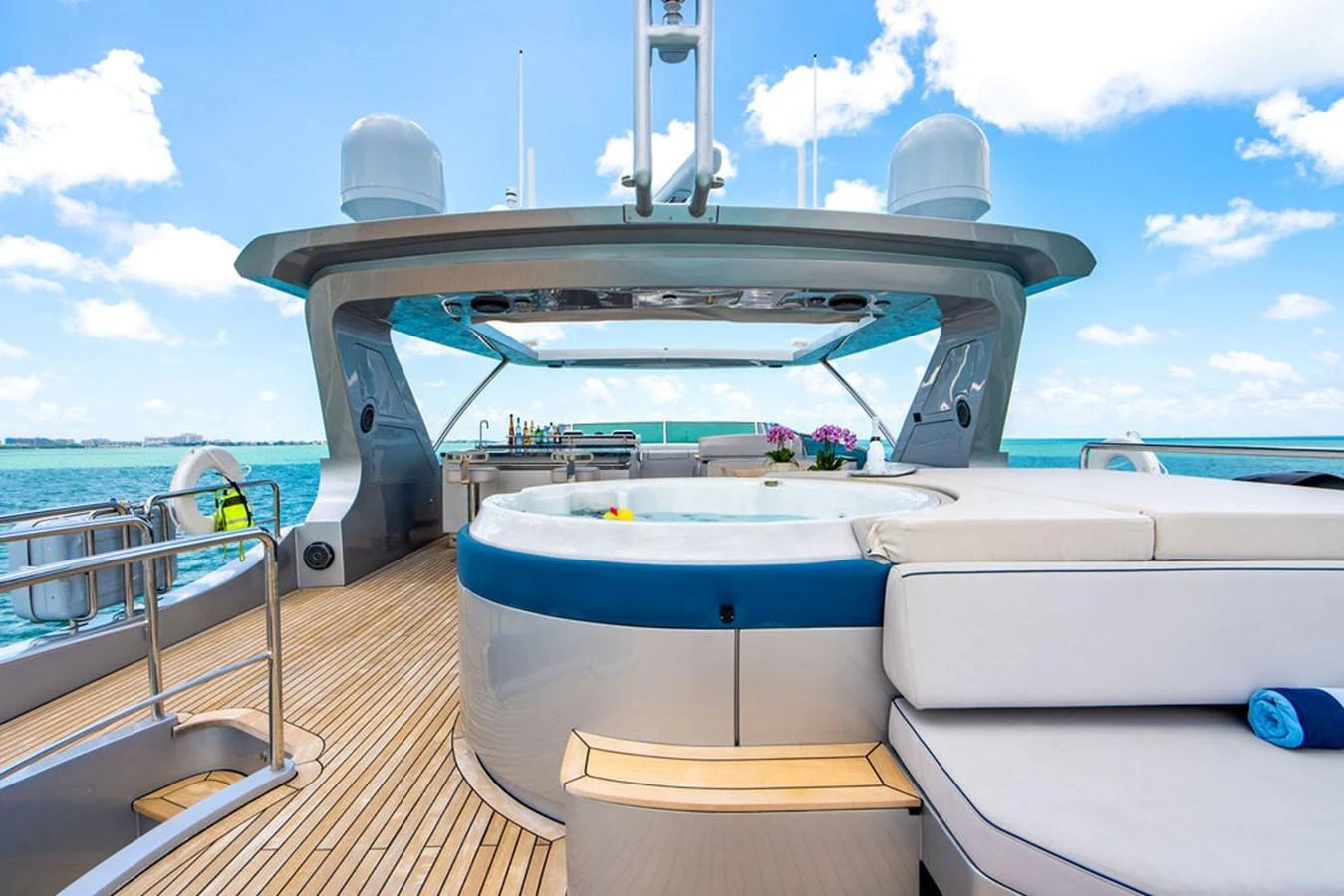 The sundeck features a luxurious hot tub and ample seating with a stunning ocean view. aboard BEAUTIFUL M Yacht for Sale