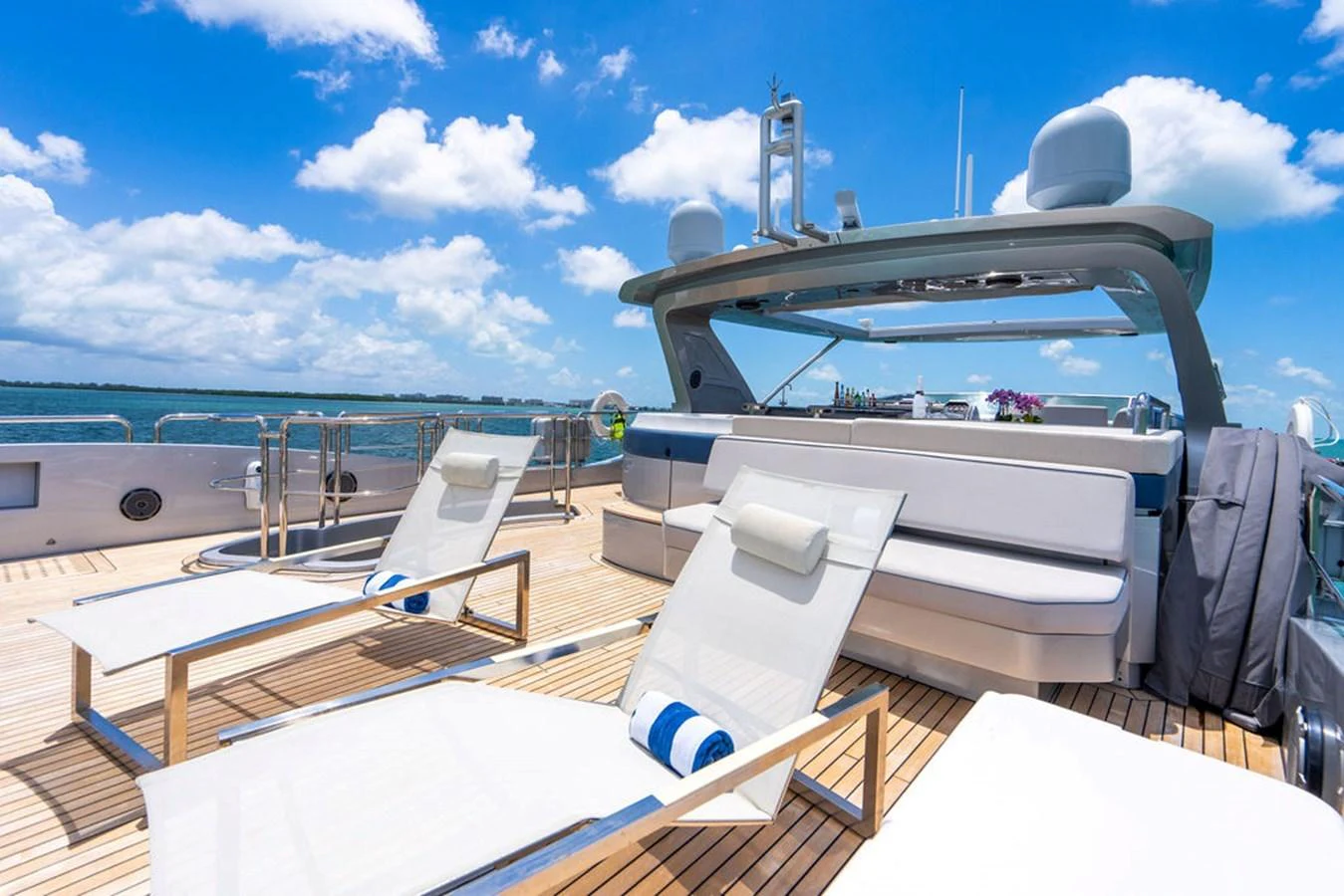 The sundeck offers a luxurious space for relaxation with comfortable loungers and a stunning view of the sea. aboard BEAUTIFUL M Yacht for Sale