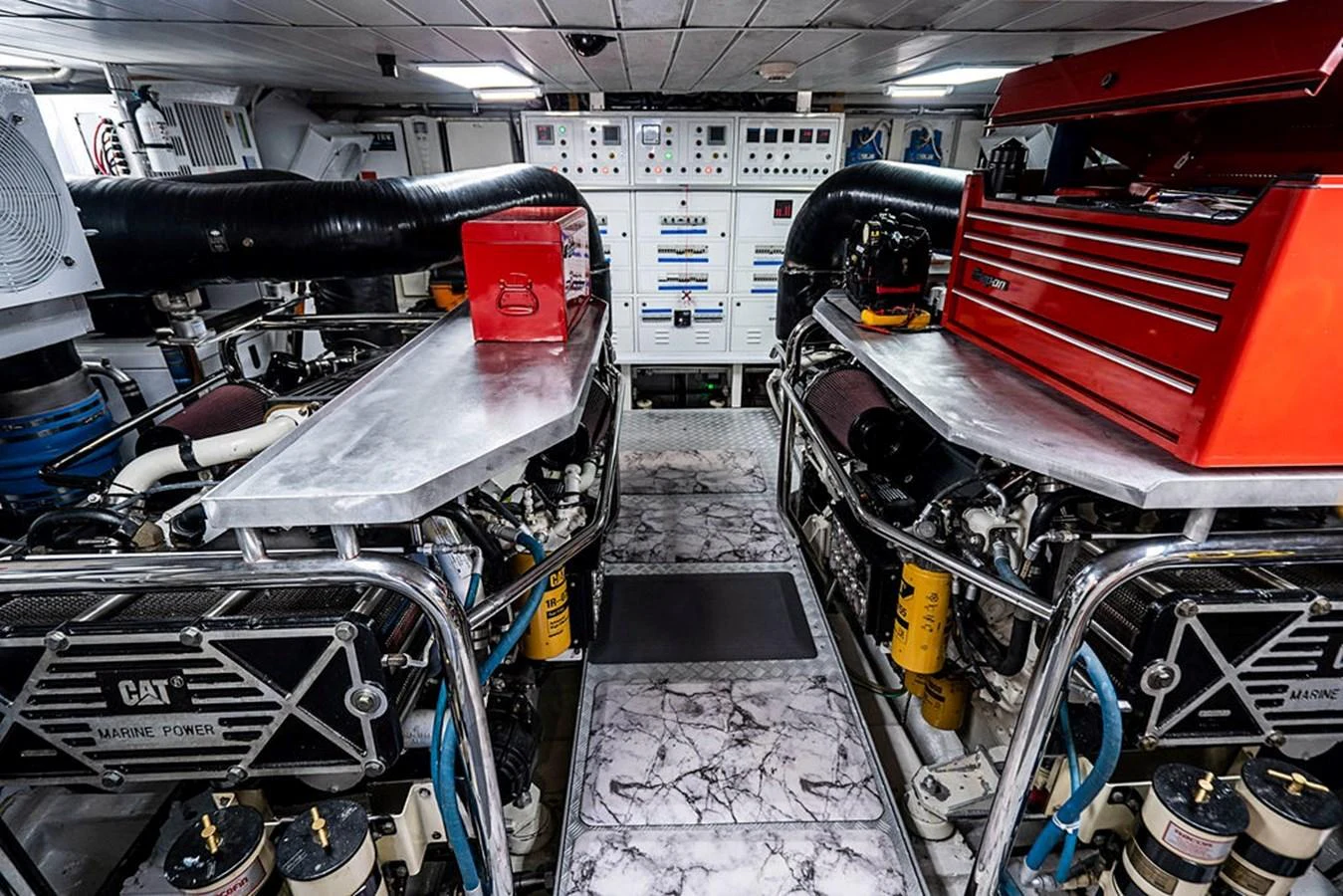 The engine room is meticulously organized with advanced machinery and tools. aboard BEAUTIFUL M Yacht for Sale