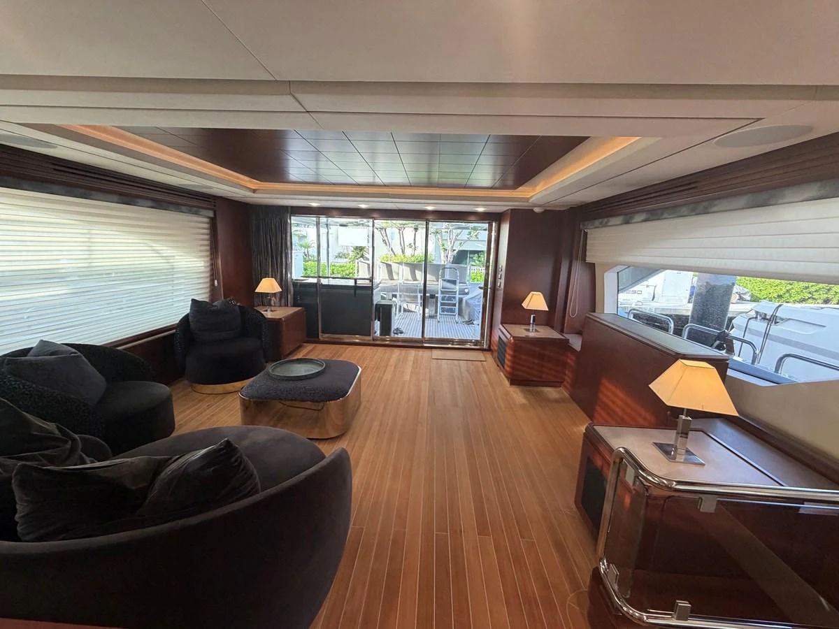 The yacht's salon features elegant seating and ample natural light through large windows. aboard BEAUTIFUL M Yacht for Sale