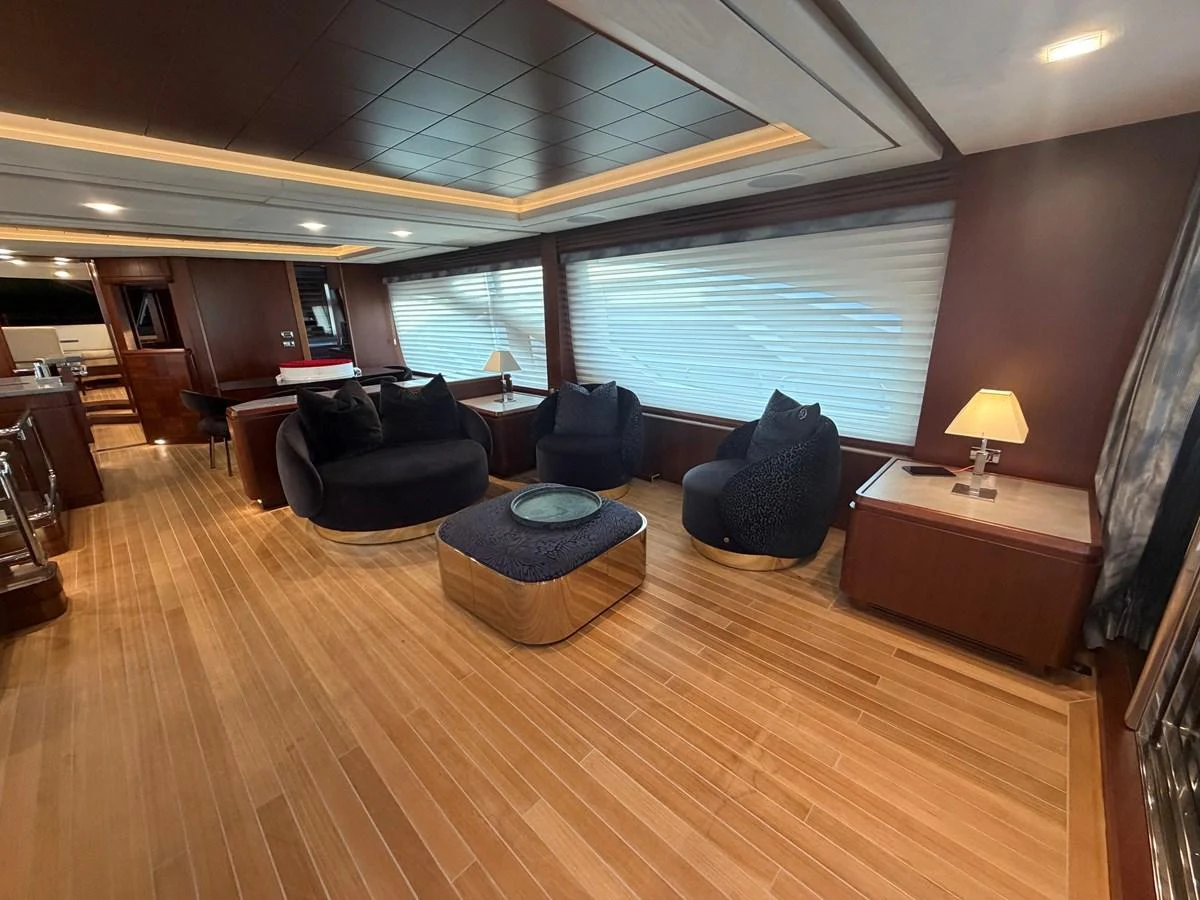 The yacht's interior features a spacious and elegantly designed lounge area with comfortable seating and warm lighting. aboard BEAUTIFUL M Yacht for Sale