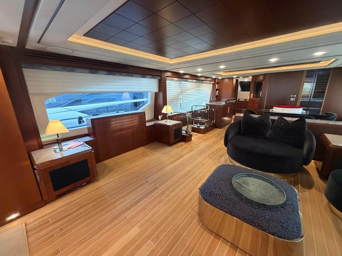 The yacht's salon features elegant wood paneling, plush seating, and ample natural light. aboard BEAUTIFUL M Yacht for Sale