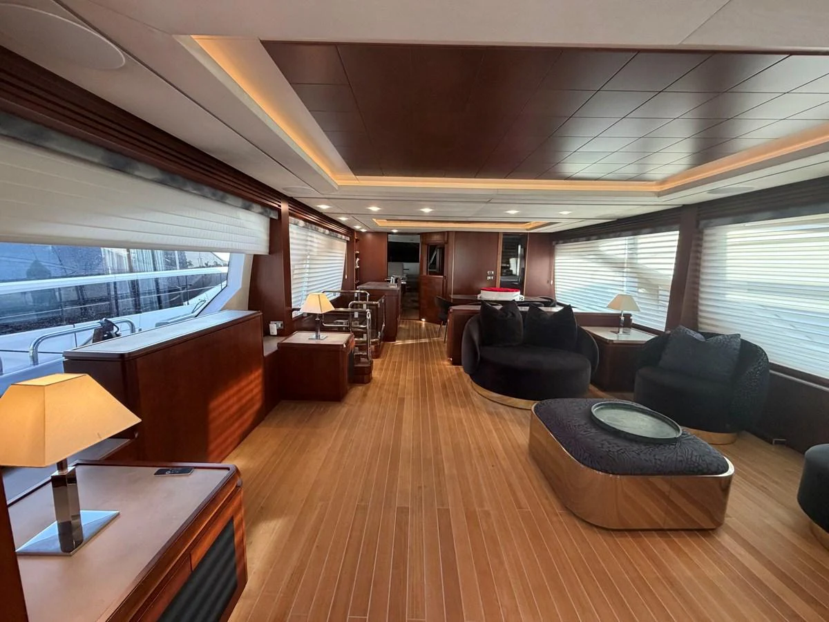 The salon features elegant wood finishes, plush seating, and ample natural light. aboard BEAUTIFUL M Yacht for Sale