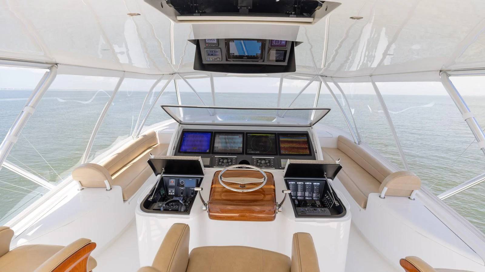 The helm station offers a commanding view with state-of-the-art navigation equipment and luxurious seating. aboard CE Yacht for Sale