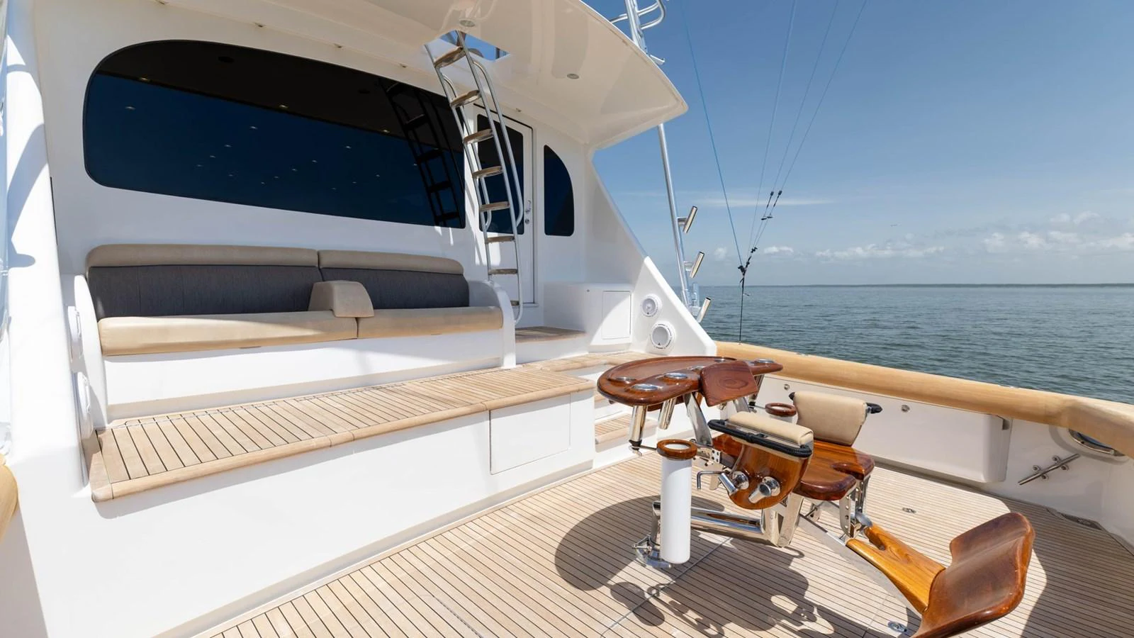 The aft deck features a comfortable seating area and a well-equipped fishing station, perfect for leisurely days on the water. aboard CE Yacht for Sale