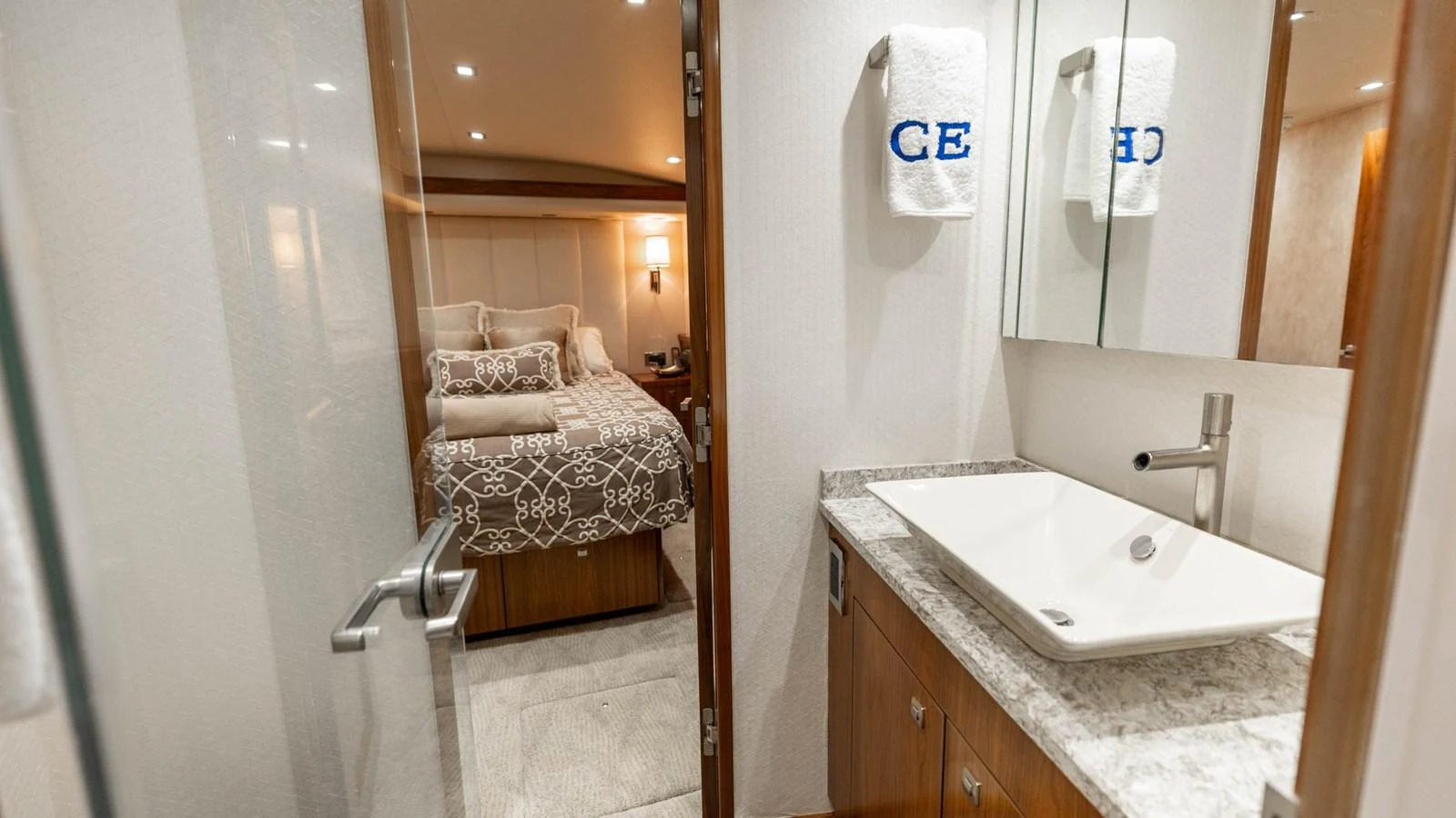 The image showcases a luxurious stateroom with an en-suite bathroom, featuring elegant decor and modern amenities. aboard CE Yacht for Sale