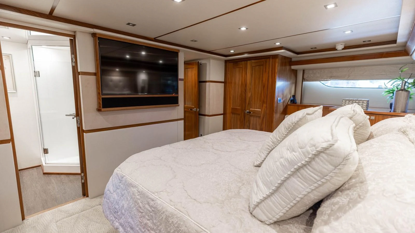 The master stateroom features a luxurious bed, ample storage, and an ensuite bathroom. aboard CE Yacht for Sale