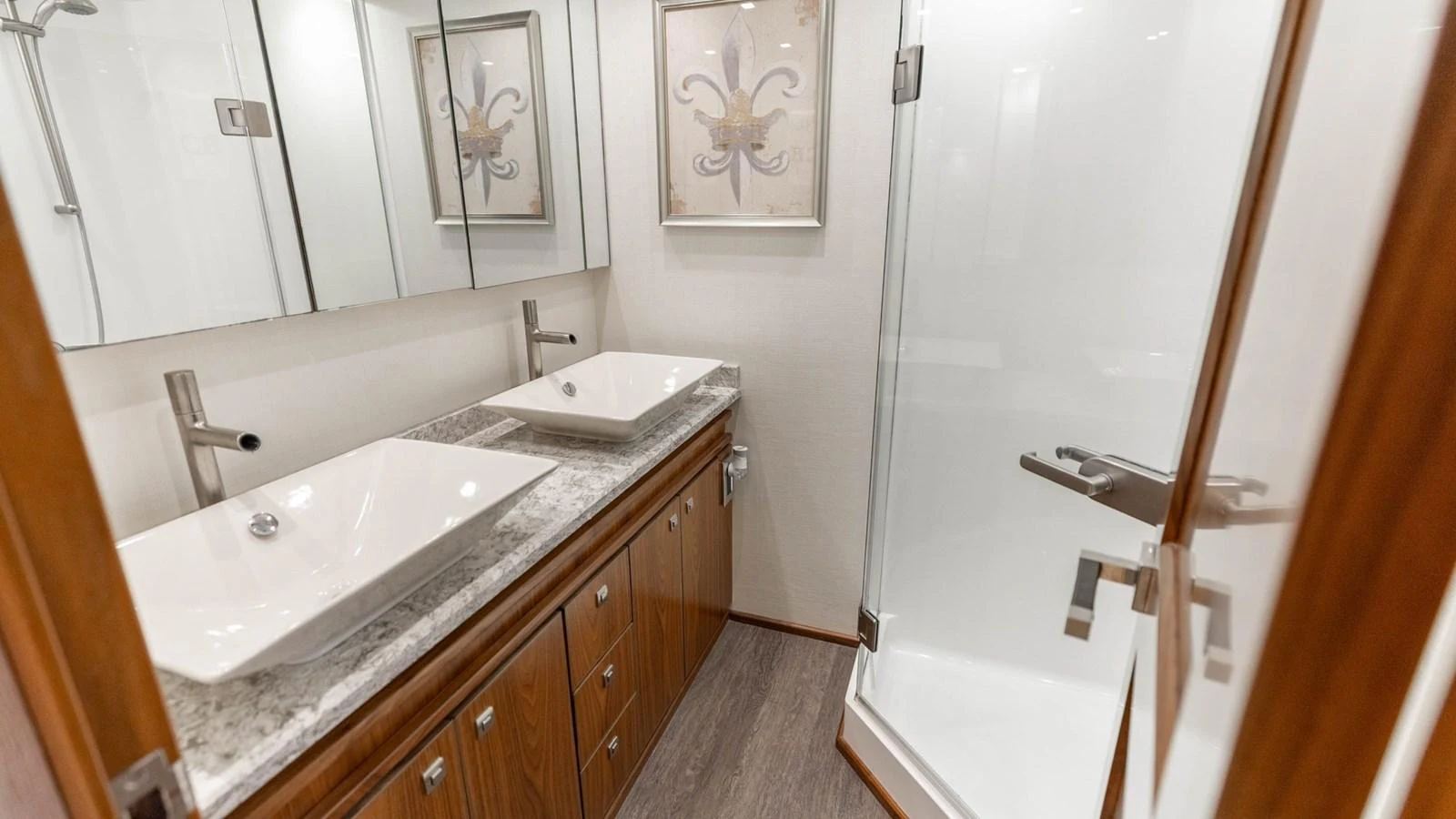 The yacht's bathroom features a modern design with dual sinks and a spacious shower. aboard CE Yacht for Sale