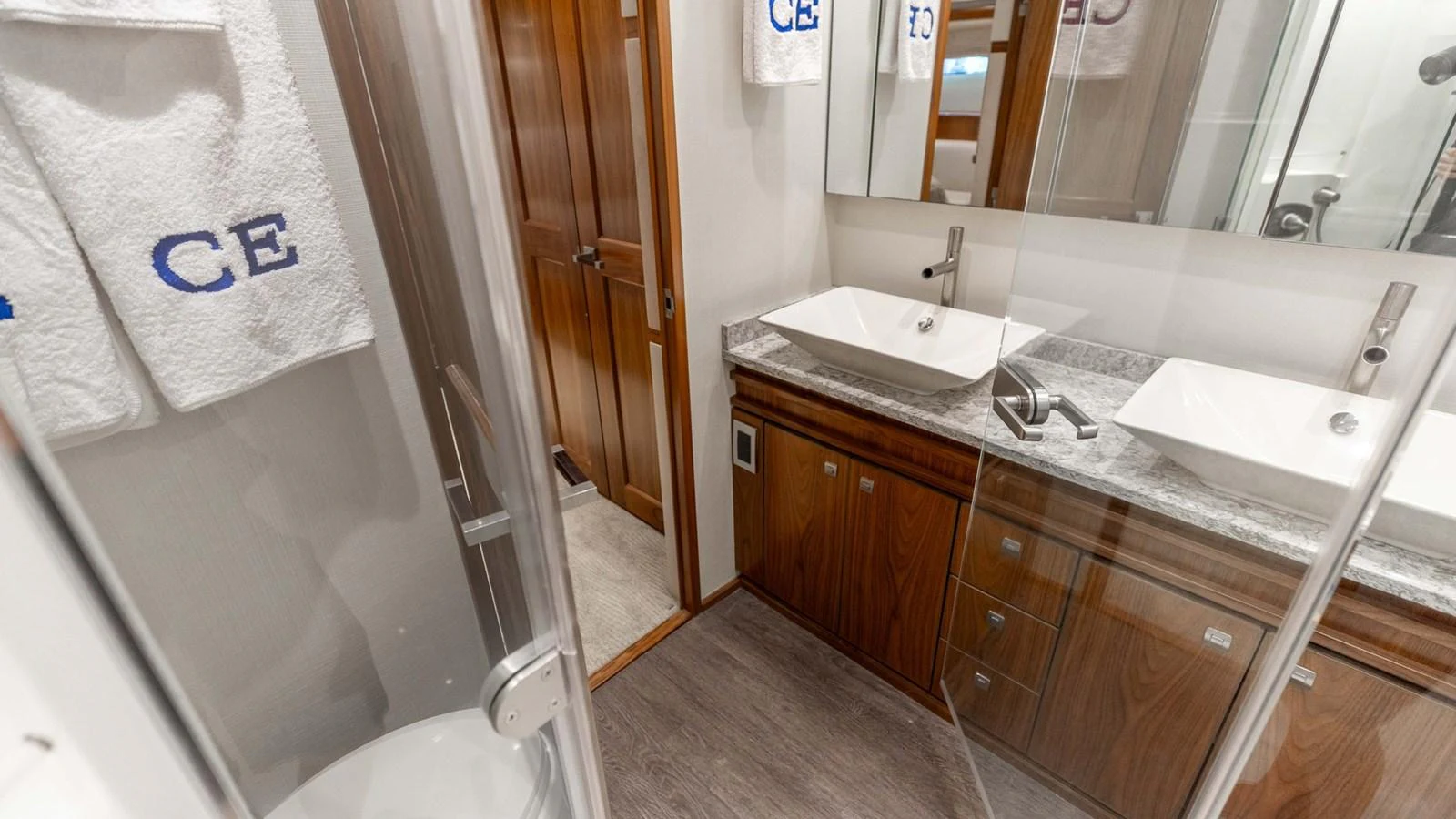 The yacht's bathroom features modern fixtures and elegant wooden cabinetry. aboard CE Yacht for Sale