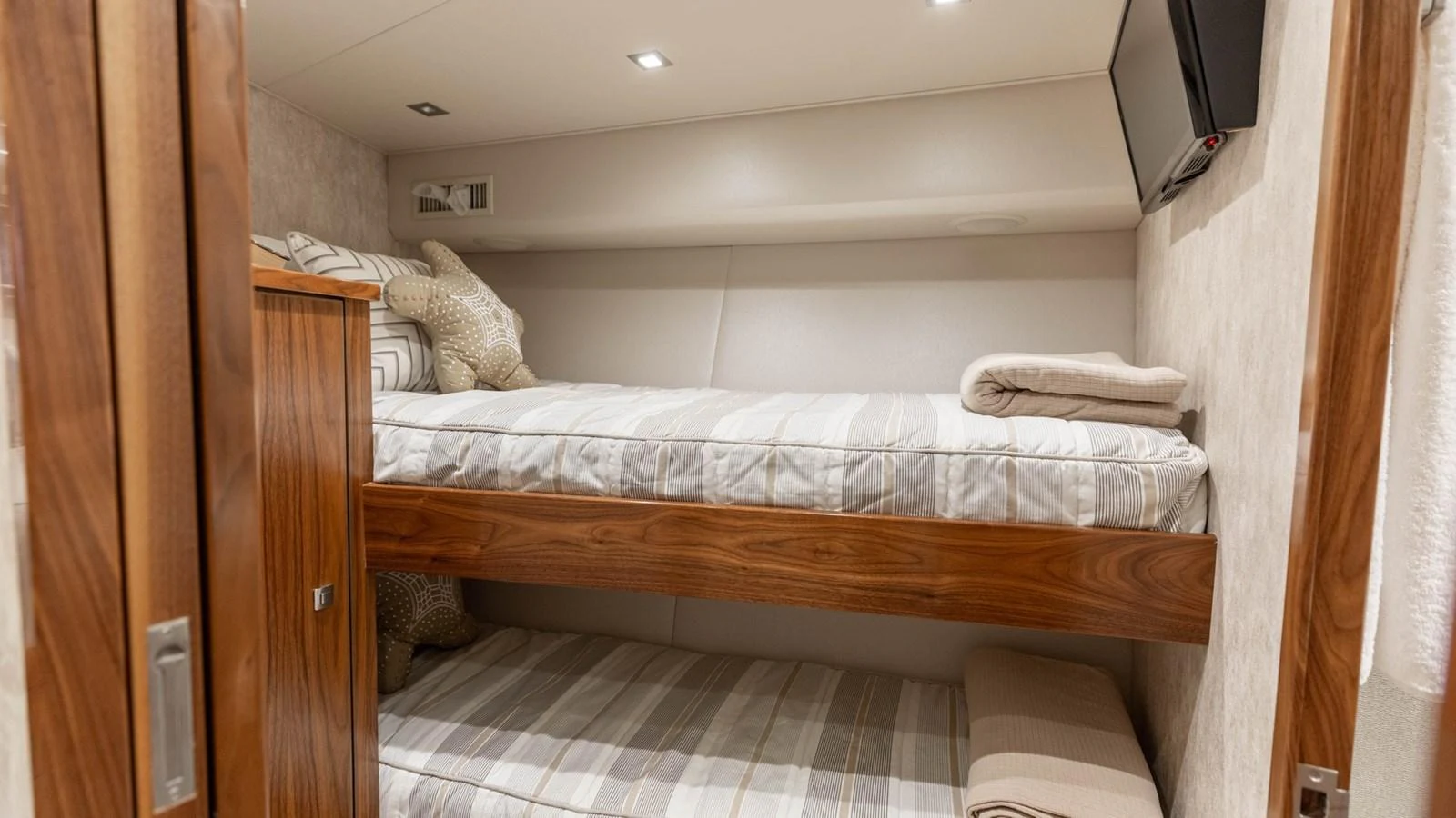 The cozy bunk cabin features comfortable bedding and modern amenities for a restful stay. aboard CE Yacht for Sale