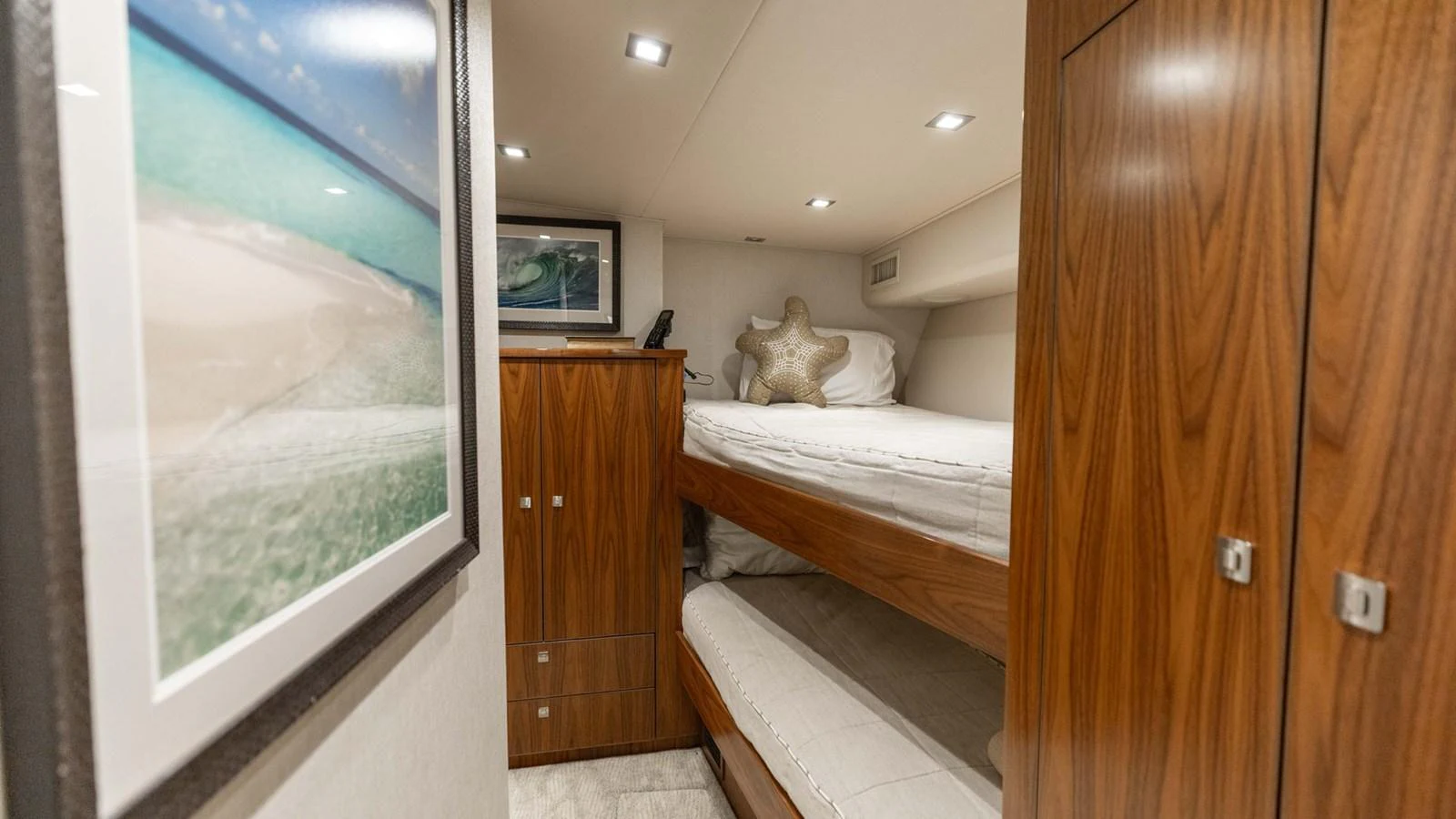 A cozy cabin with wooden finishes and bunk beds, perfect for a restful night at sea. aboard CE Yacht for Sale