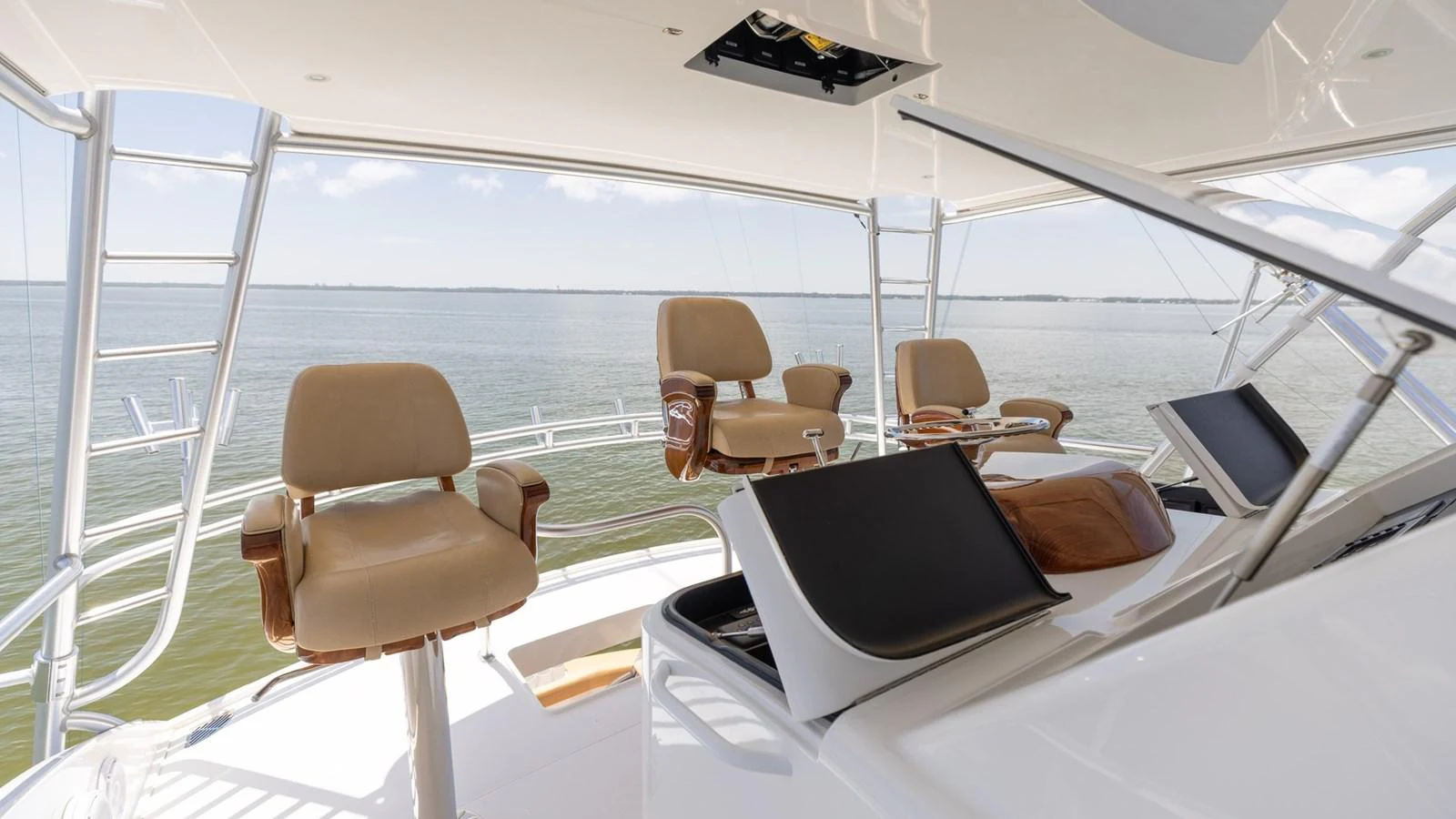The helm area features comfortable seating with a panoramic view of the water. aboard CE Yacht for Sale