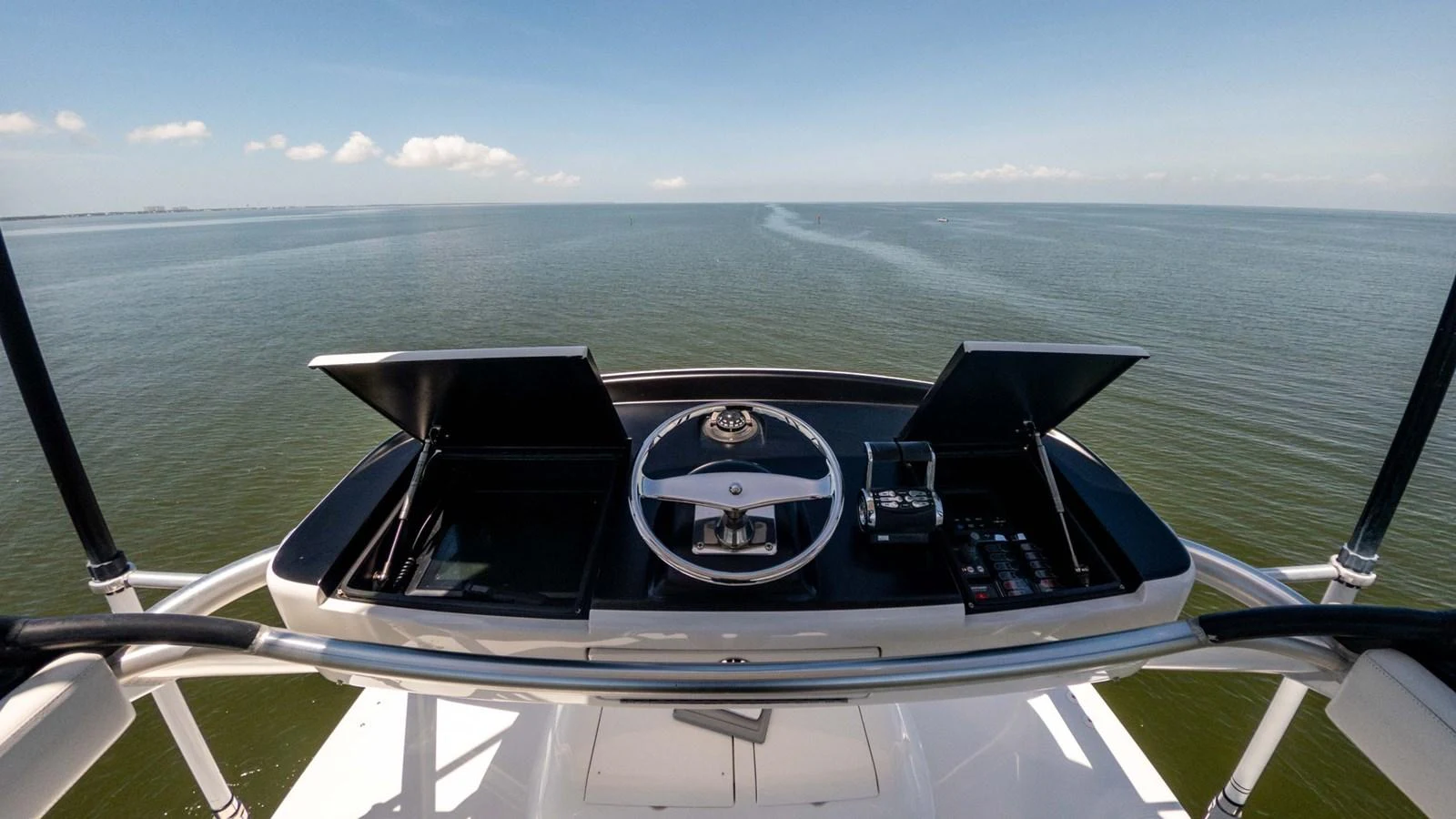 The helm station offers a commanding view of the open sea, equipped with modern navigation instruments. aboard CE Yacht for Sale