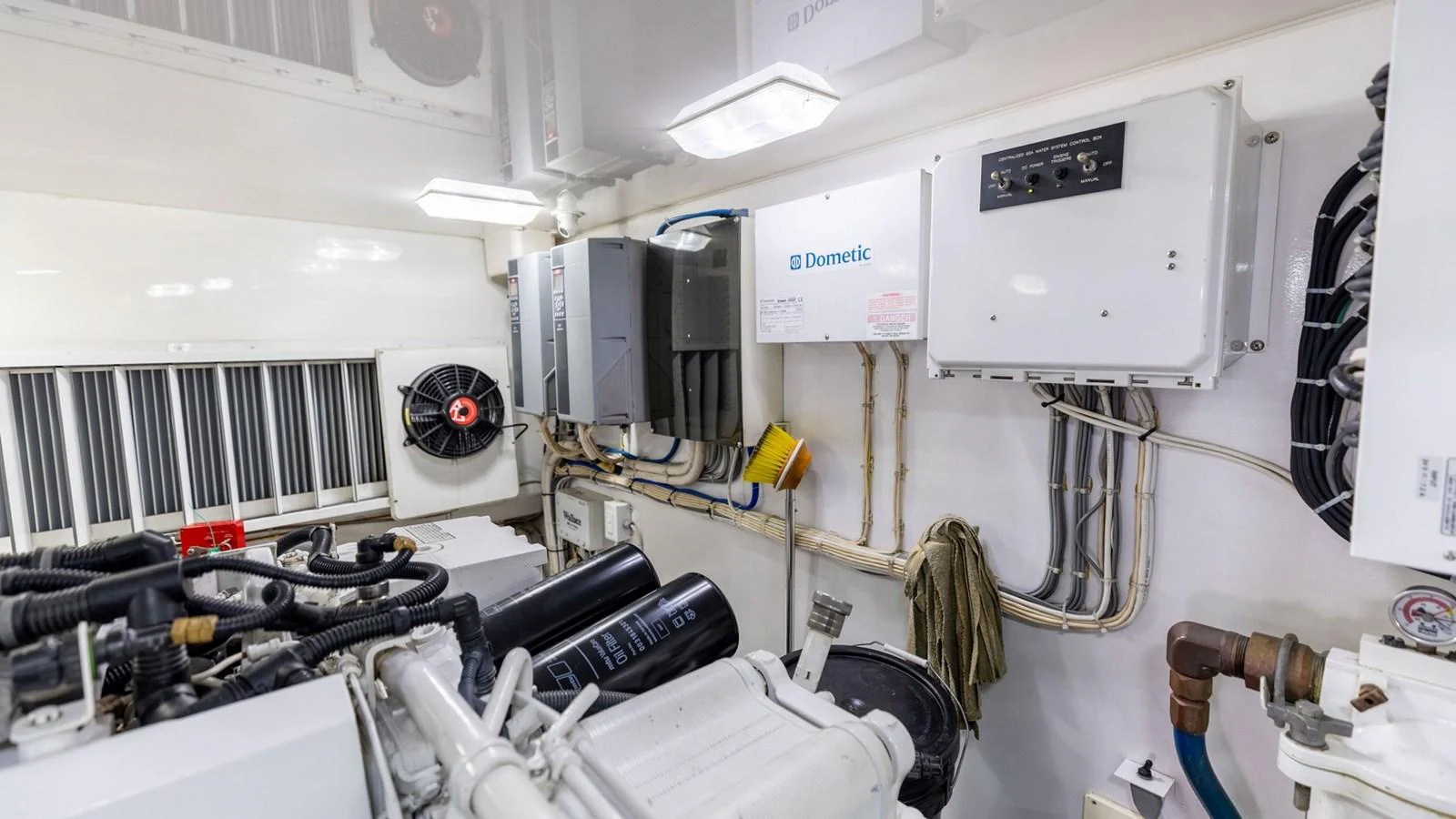 The image showcases the well-organized engine room of the yacht, featuring various technical equipment and systems. aboard CE Yacht for Sale