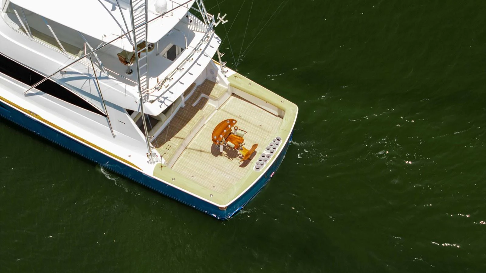 The yacht's aft deck features a spacious area with a central seating arrangement, perfect for relaxation and fishing. aboard CE Yacht for Sale