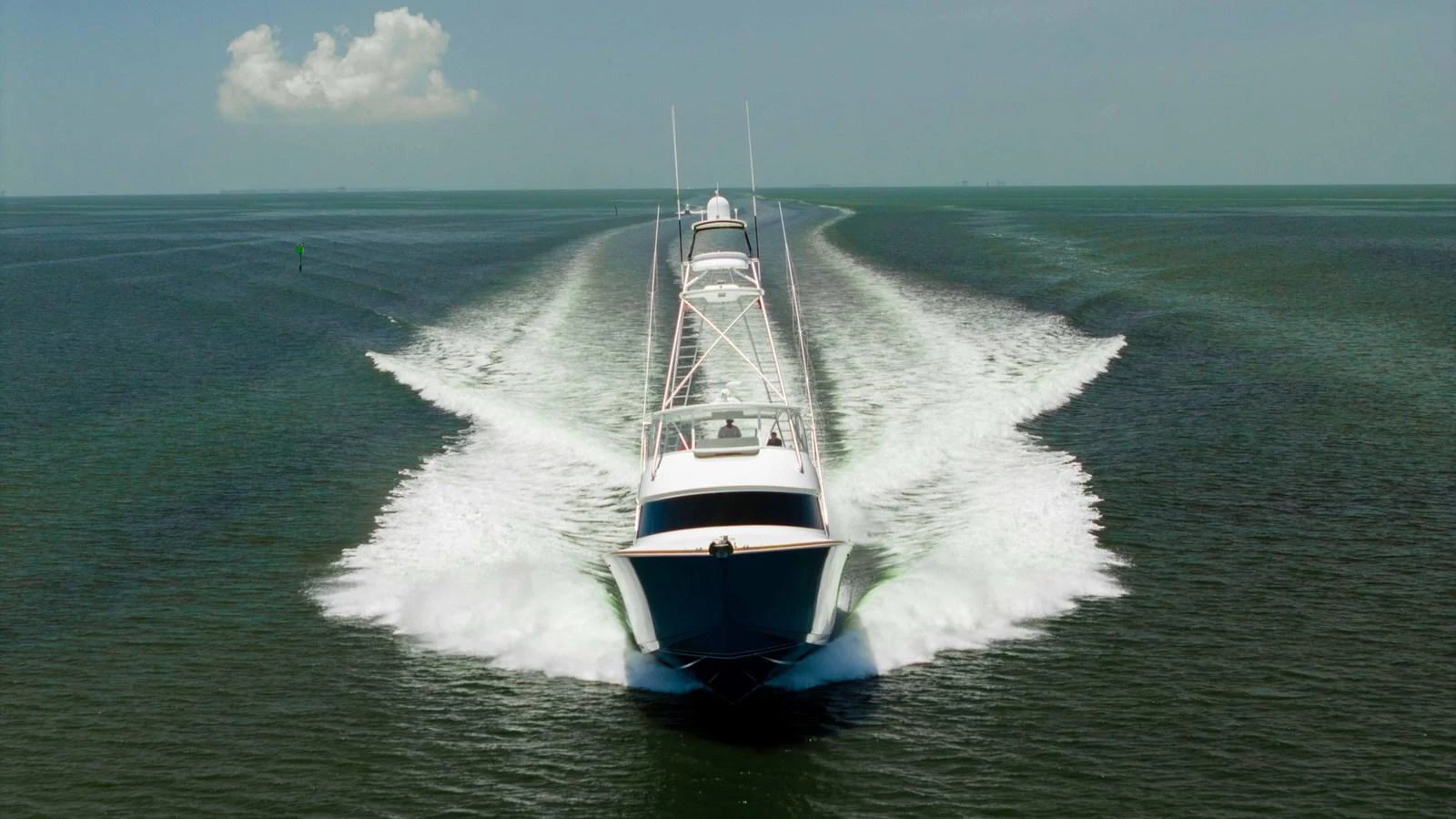 A sleek yacht cuts through the water, leaving a dynamic wake behind. aboard CE Yacht for Sale