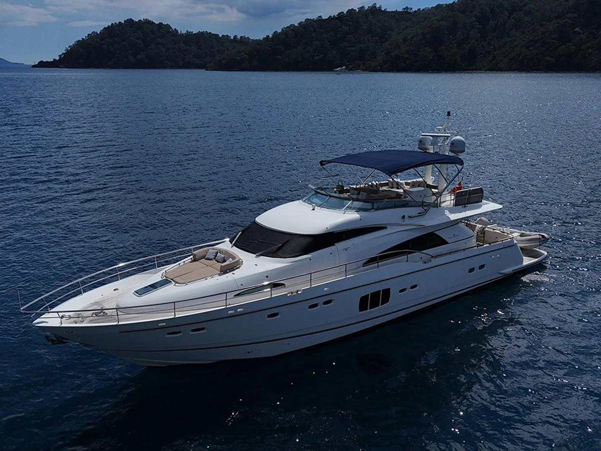 A sleek and elegant yacht cruising on calm waters with a scenic backdrop. aboard SEDEF Yacht for Sale