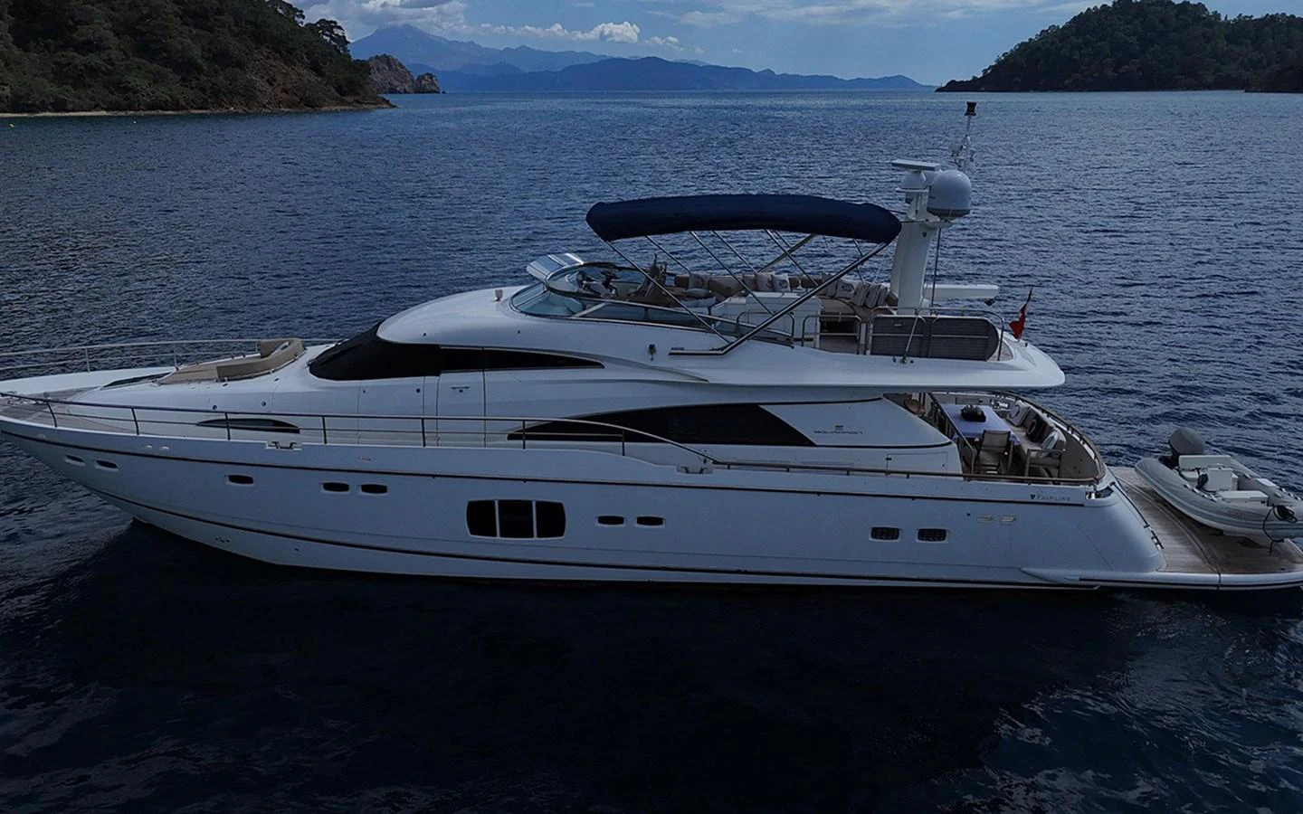 A sleek and elegant yacht cruises through serene waters, showcasing its luxurious design and spacious decks. aboard SEDEF Yacht for Sale